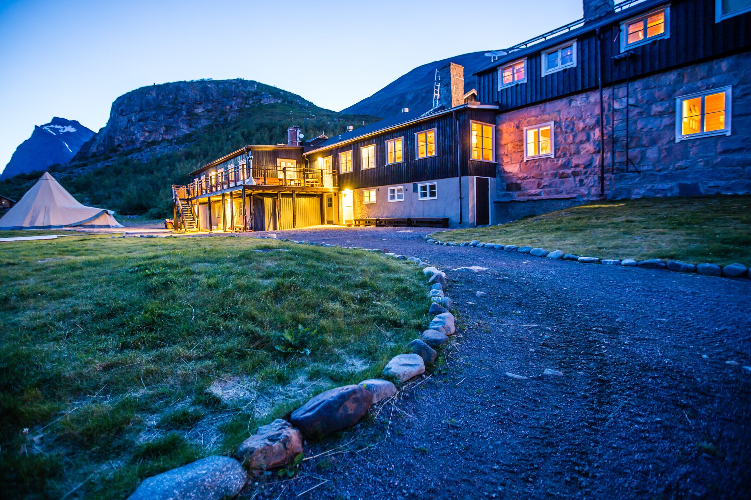 Hus i skymning vid Svenska Turistföreningens fjällstation Kebnekaise i Lappland.